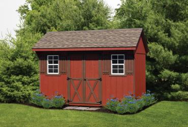 quaker shed with t1-11 siding painted red and with brown trim.