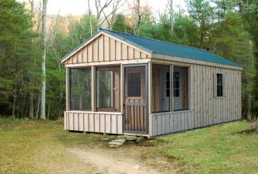 aframe cabin with board and batten siding and porch