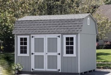 Barn style shed with DuraTemp T1-11 siding, classic doors and wider window trim.