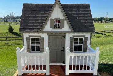 front of custom playhouse with mini deck