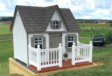 side view of small playhouse with min deck.