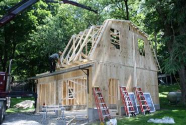 gambrel roof garage under construction, frame built