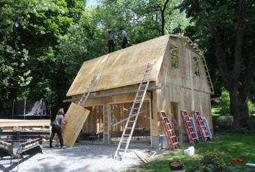 gambrel roof garage under construction, frame front view