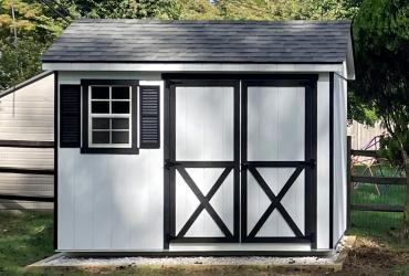 Front view of shed with 1 left window and double doors.