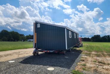 row shed barn on the truck bed being delivered.