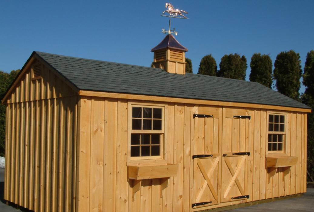 Aframe board and batten with custom door with barn strap hinges, cupola and weathervane
