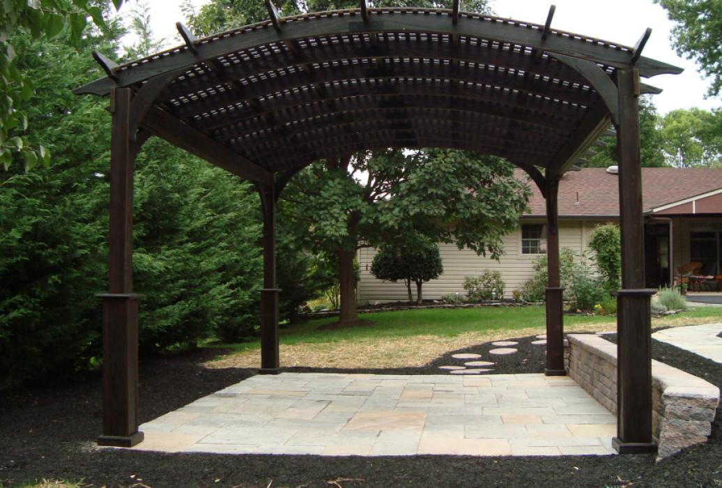 cozy arched cinder stained wood pergola
