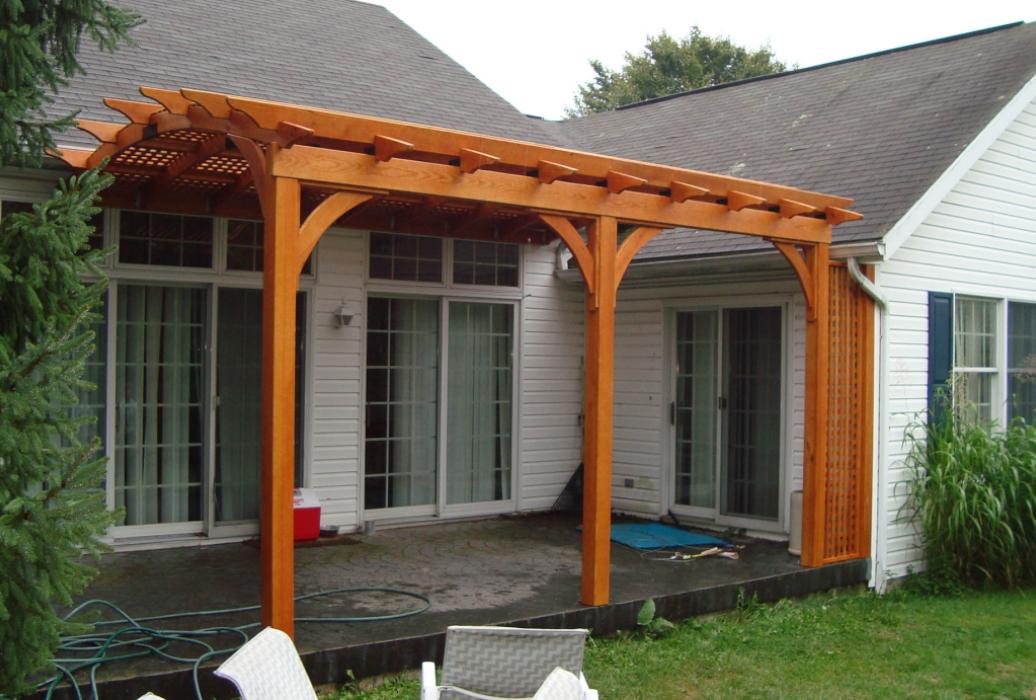 cozy arched cedar stained wood pergola over deck