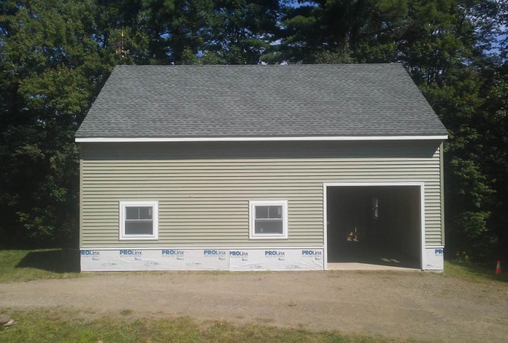GALLERY 1 front of garage showing garage door and two windows