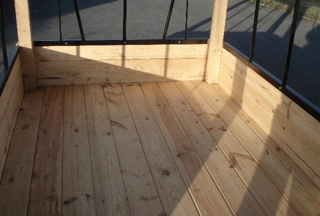 Wooden floor of hay bale feeder
