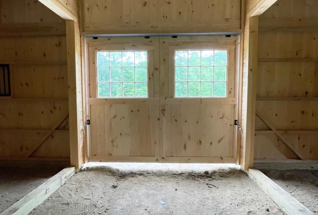 Interior aisle barn with open areas off the sides, prior to paver floor. Interior aisle barn with open areas off the sides, prior to paver floor.