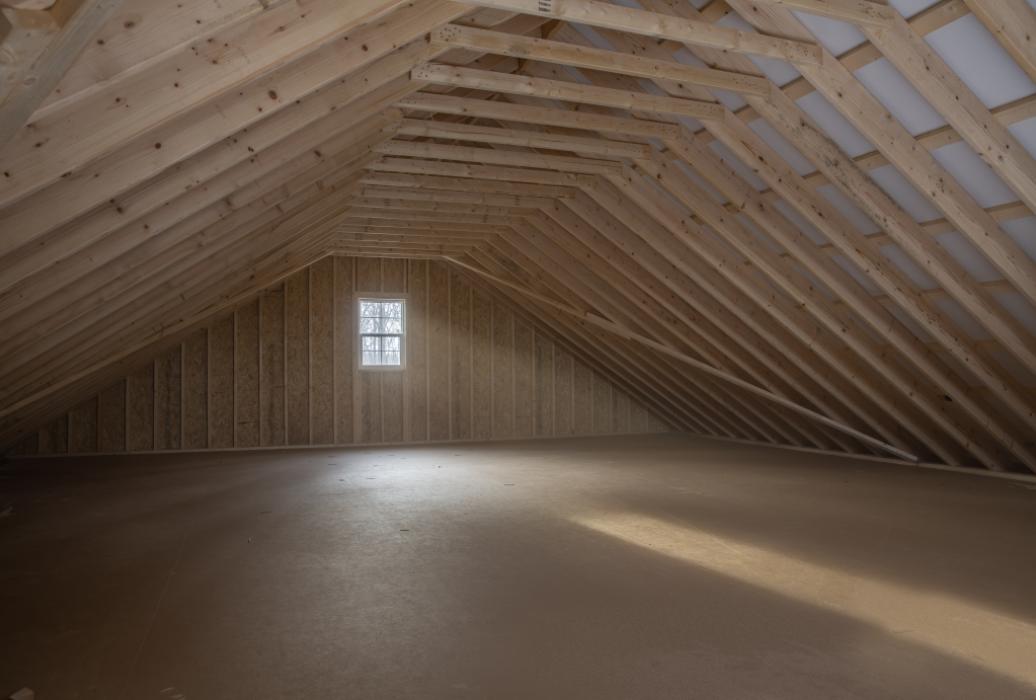 attic space attic space in 29x34 barn -red with black trim and a stone front wall
