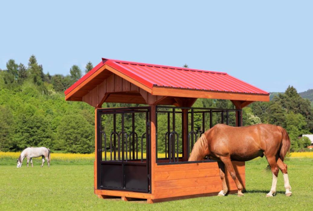 Horse eating from a round hay bale feeder with a roof