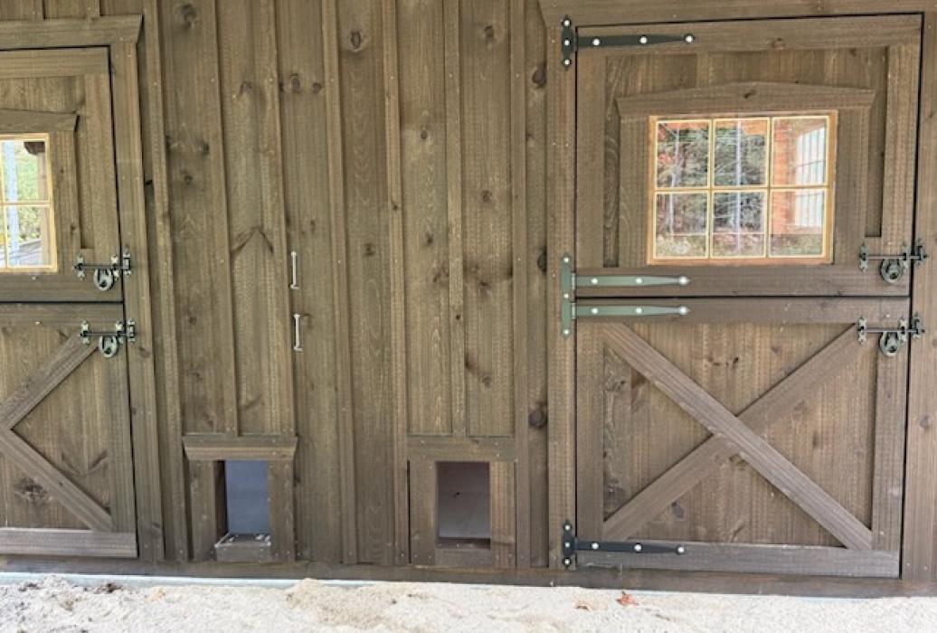 Large barn stall section used as a chicken coop -chicken &amp; exterior door