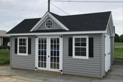 home office shed in grey vinyl siding with black shingles