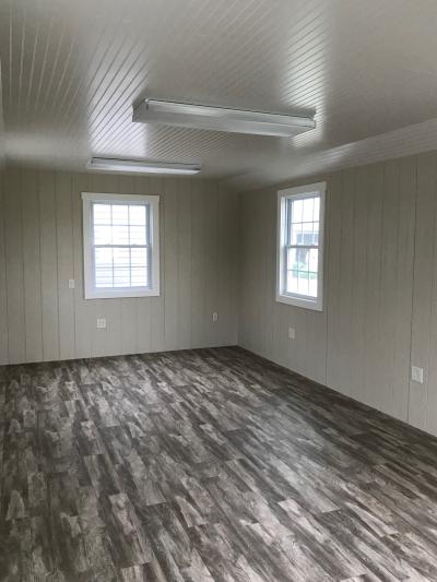 backyard storage shed interior that has been finished out for an office