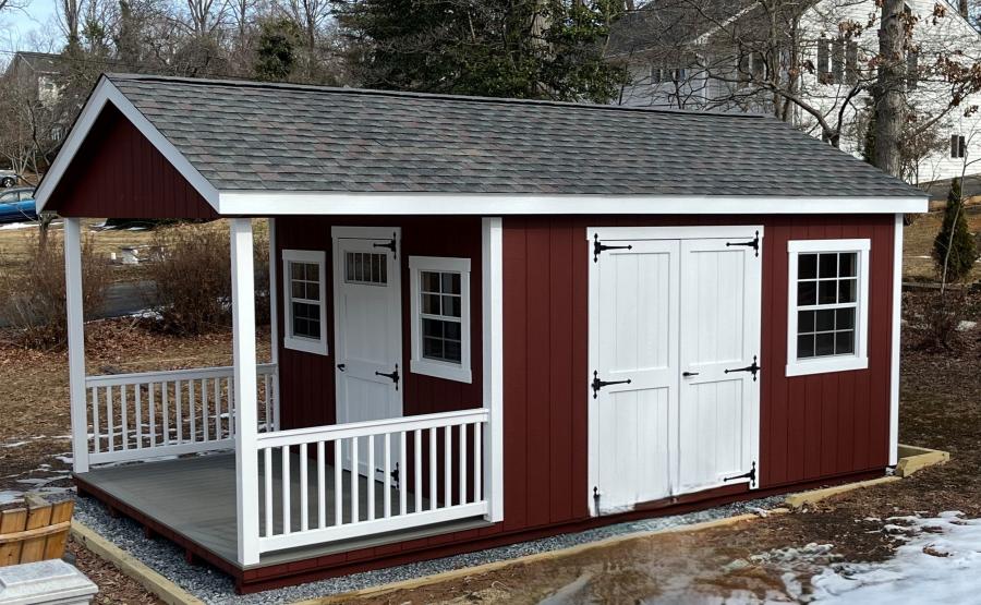 Red storage shed with porch